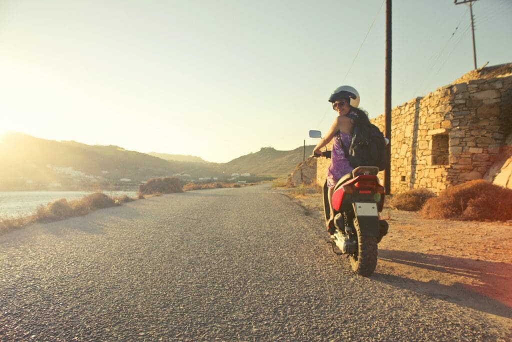 A young woman courageously rides a local motorbike on an adventure through town