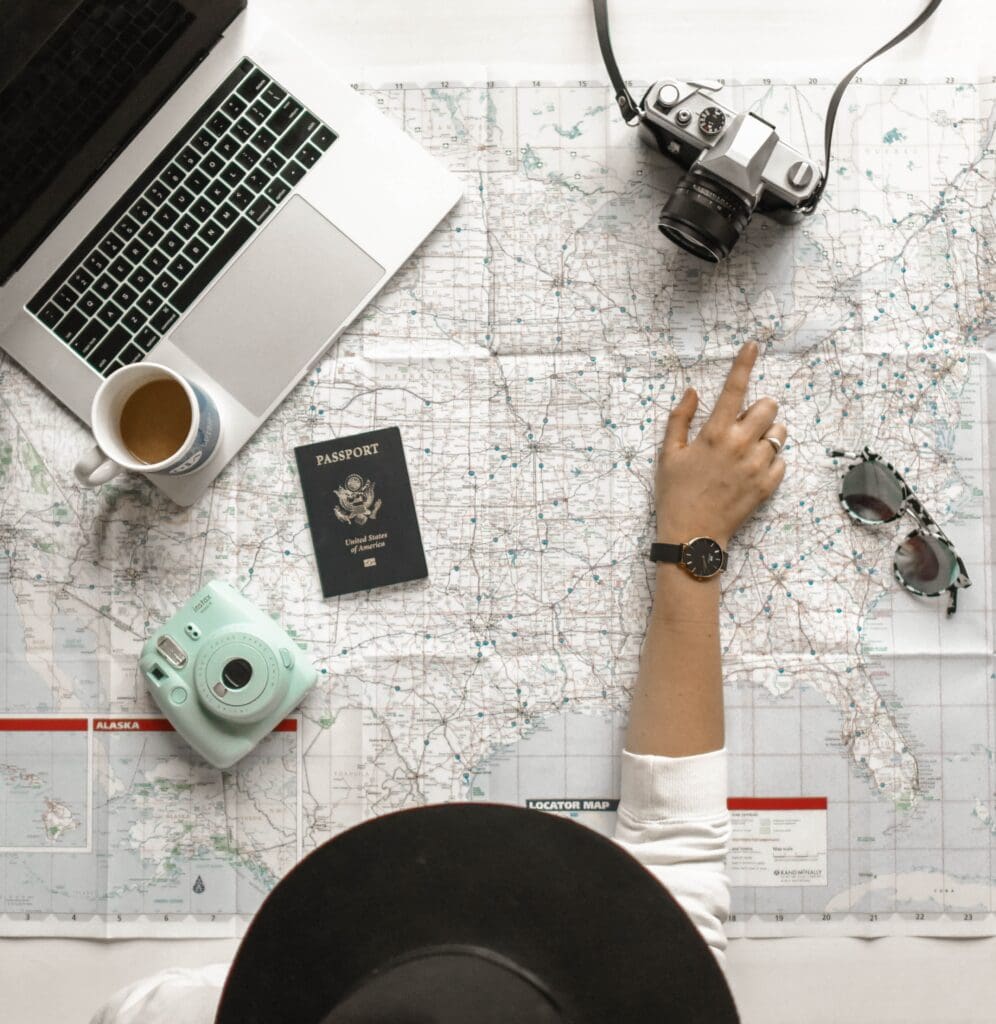 Culture-focused travel improves key life skills. A traveler has a map and a laptop out to plan the next life-changing experience